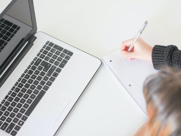 Woman writing on notepad